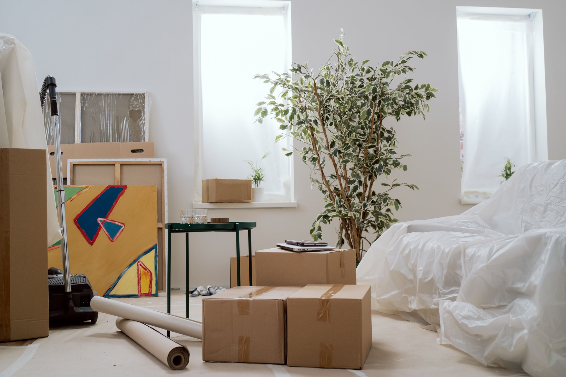 Moving in out, cardboard boxes with packed things, renting selling an apartment, changing location, renovation, painting walls